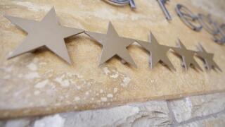 Five stars on a hotel logo at the entrance