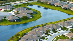 American gated community houses in rural US suburbs. View from above of large residential homes in small town in southwest Florida.