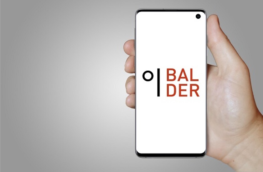 A man holds a smartphone displaying the logo of company Fast. Balder listed on OMX Stockholm. Grey gradient in the background. Credit: PIXDUCE