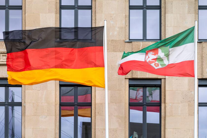 Flags of the federal state of North Rhine Westphalia and the German flag outside a government building, Dusseldorf, NRW, Germany